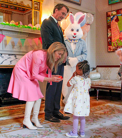 फ़र्स्ट लेडी, गवर्नर और ईस्टर बन्नी से मुलाकात करती छोटी लड़की